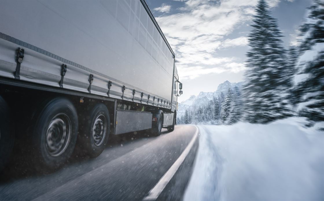 A truck driving on a snowy road
AI-generated content may be incorrect.